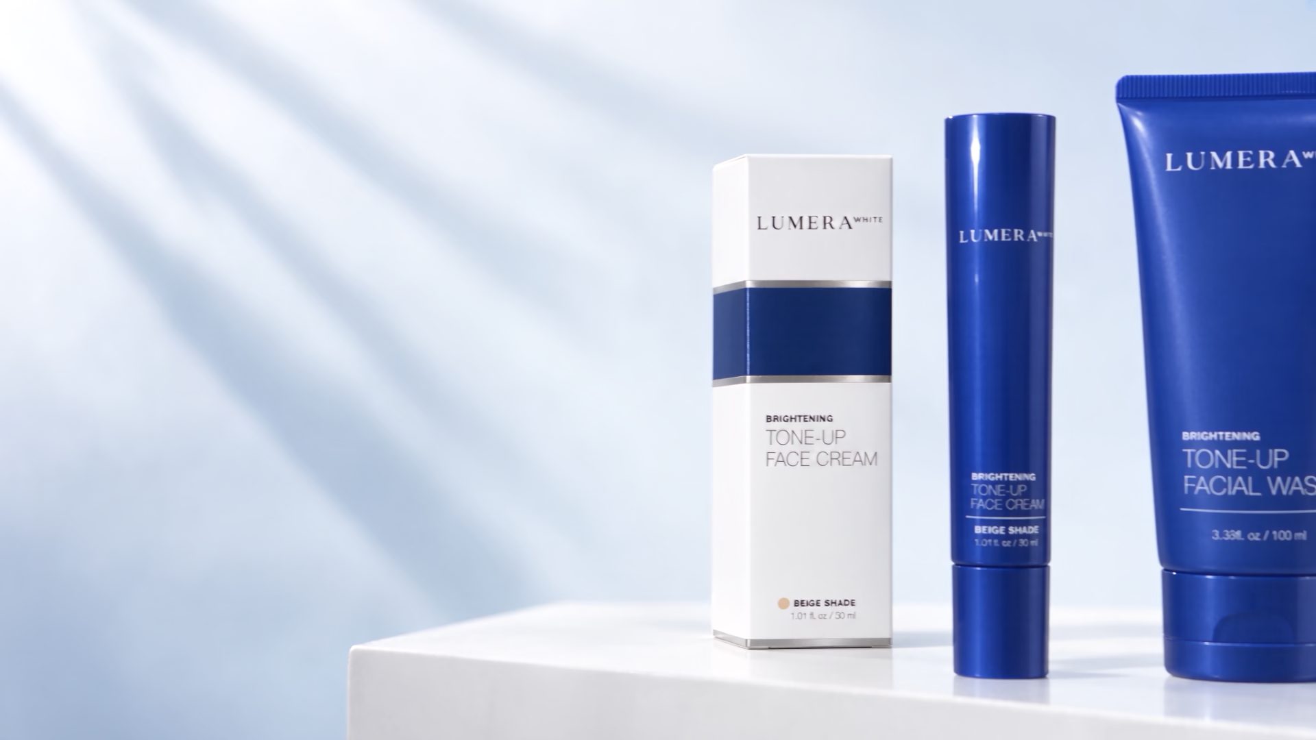 The Lumera products and cartons on a white plinth against a pale blue wall